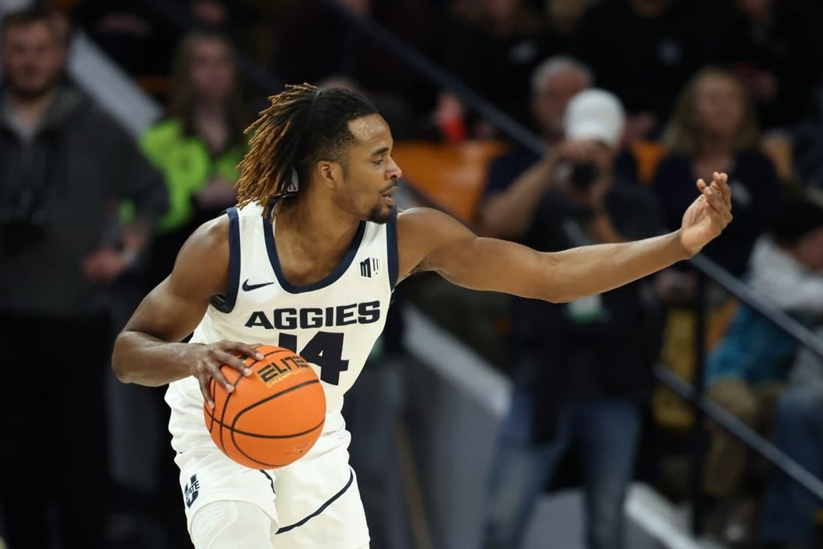 Jan 20, 2024; Logan, Utah, USA; Utah State Aggies guard Josh Uduje (14) calls a play against the Fresno State Bulldogs during the second half at Dee Glen Smith Spectrum.