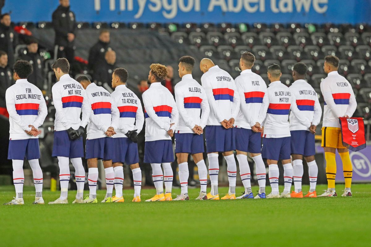 The USMNT team lines up before friendly vs. Wales, with social justice messages on their backs.