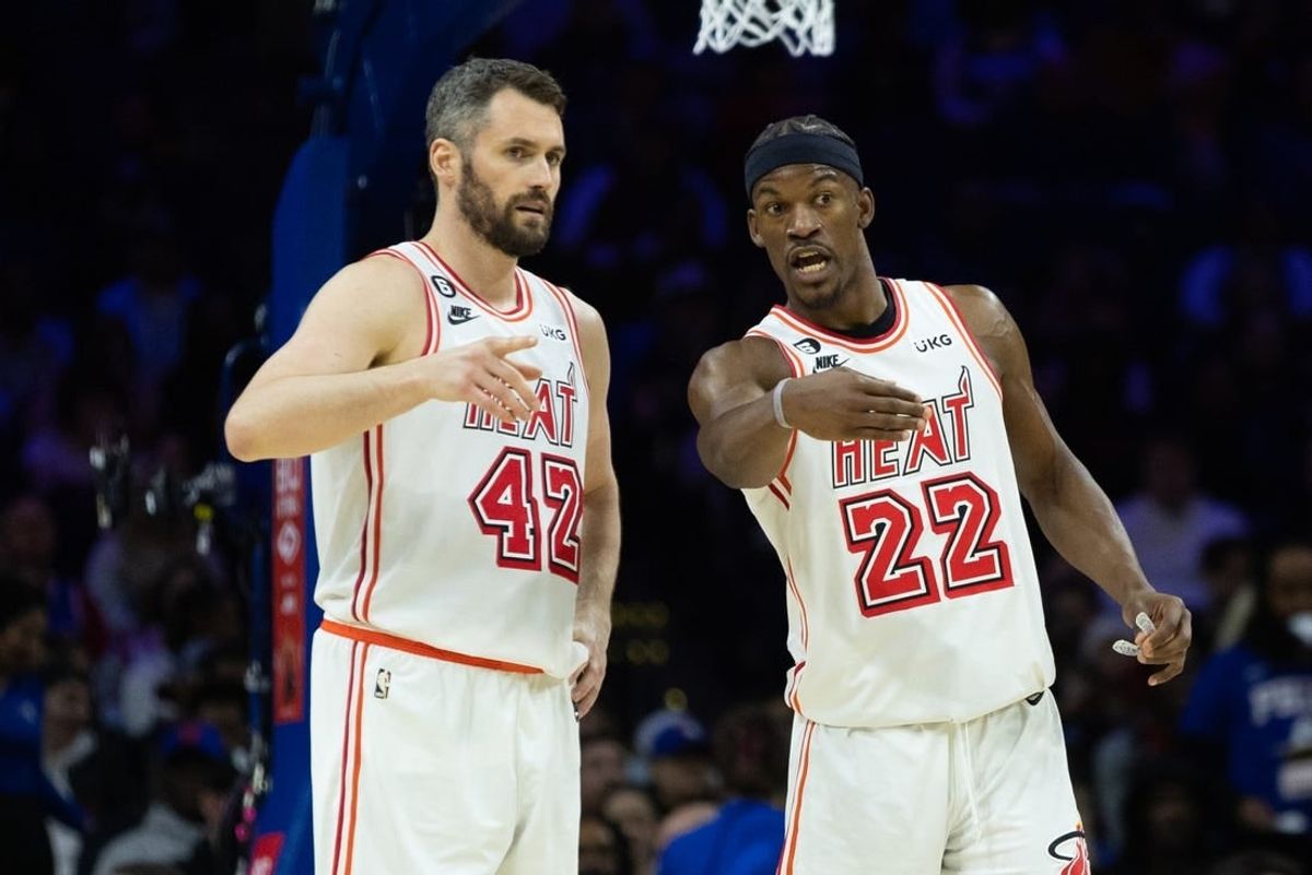 Feb 27, 2023; Philadelphia, Pennsylvania, USA; Miami Heat forward Jimmy Butler (22) talks with forward Kevin Love (42) during a break in action in the second quarter against the Philadelphia 76ers at Wells Fargo Center.