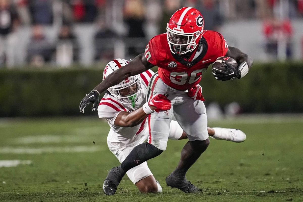 Nov 11, 2023; Athens, Georgia, USA; Georgia Bulldogs running back Daijun Edwards (30) runs against Mississippi Rebels cornerback Deantre Prince (7) during the first half at Sanford Stadium.