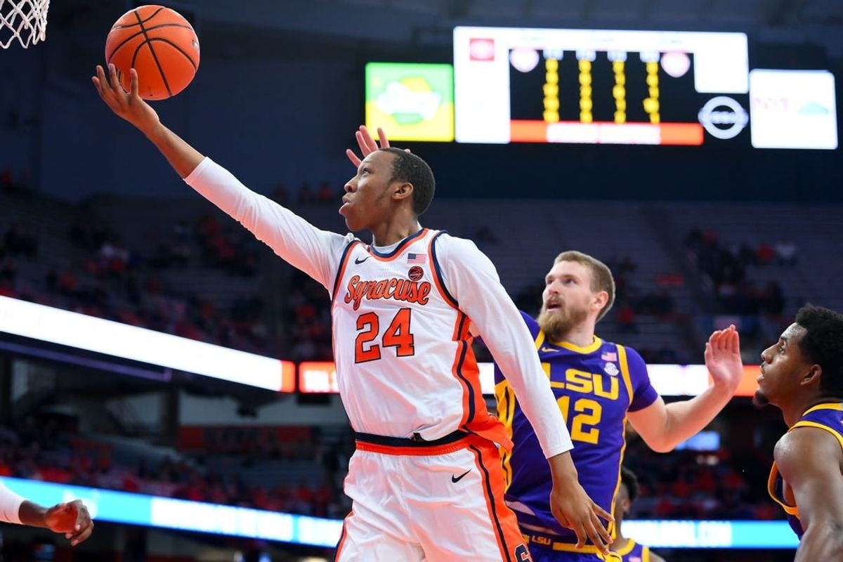 Nov 28, 2023; Syracuse, New York, USA; Syracuse Orange guard Quadir Copeland (24) shoots the ball in front of LSU Tigers forward Hunter Dean (12) during the second half at the JMA Wireless Dome.