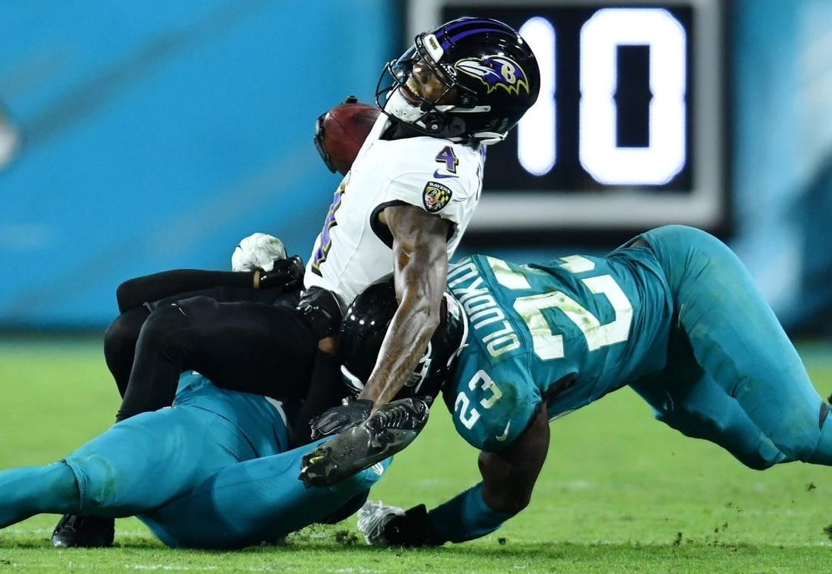 Jacksonville Jaguars cornerback Montaric Brown (30) and linebacker Foyesade Oluokun (23) make the tackle on Baltimore Ravens wide receiver Zay Flowers (4) during third quarter action. The Jacksonville Jaguars hosted the Baltimore Ravens at EverBank Stadium in Jacksonville, Florida Sunday Night, December 17, 2023. The Jaguars trailed 10 to 0 at the half and lost 23 to 7. [Bob Self/Florida Times-Union]