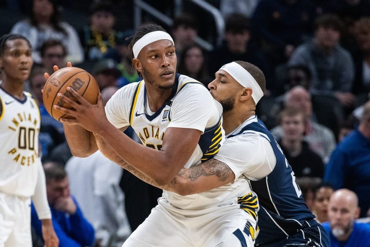 Feb 25, 2024; Indianapolis, Indiana, USA; Indiana Pacers center Myles Turner (33) holds the ball while Dallas Mavericks center Daniel Gafford (21) defends in the second half at Gainbridge Fieldhouse.