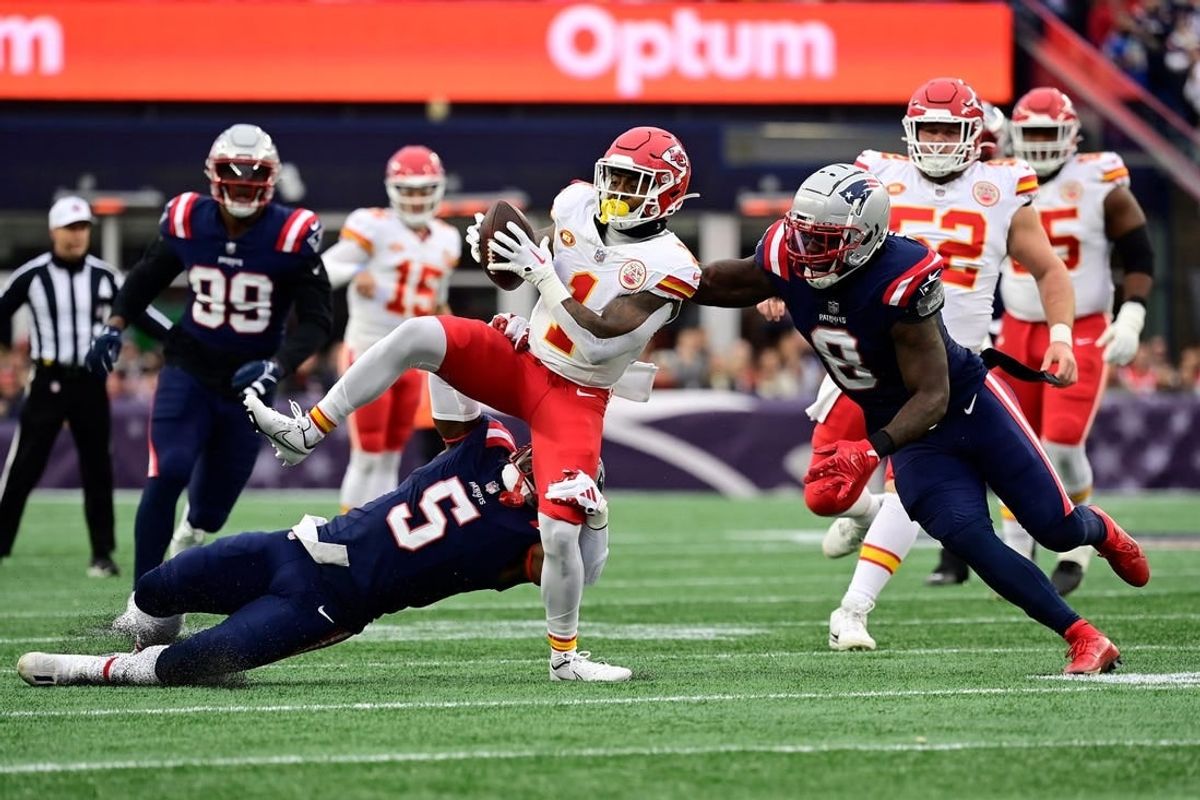 Dec 17, 2023; Foxborough, Massachusetts, USA; Kansas City Chiefs running back Jerick McKinnon (1) gets tackled by New England Patriots safety Jabrill Peppers (5) during the first half at Gillette Stadium.