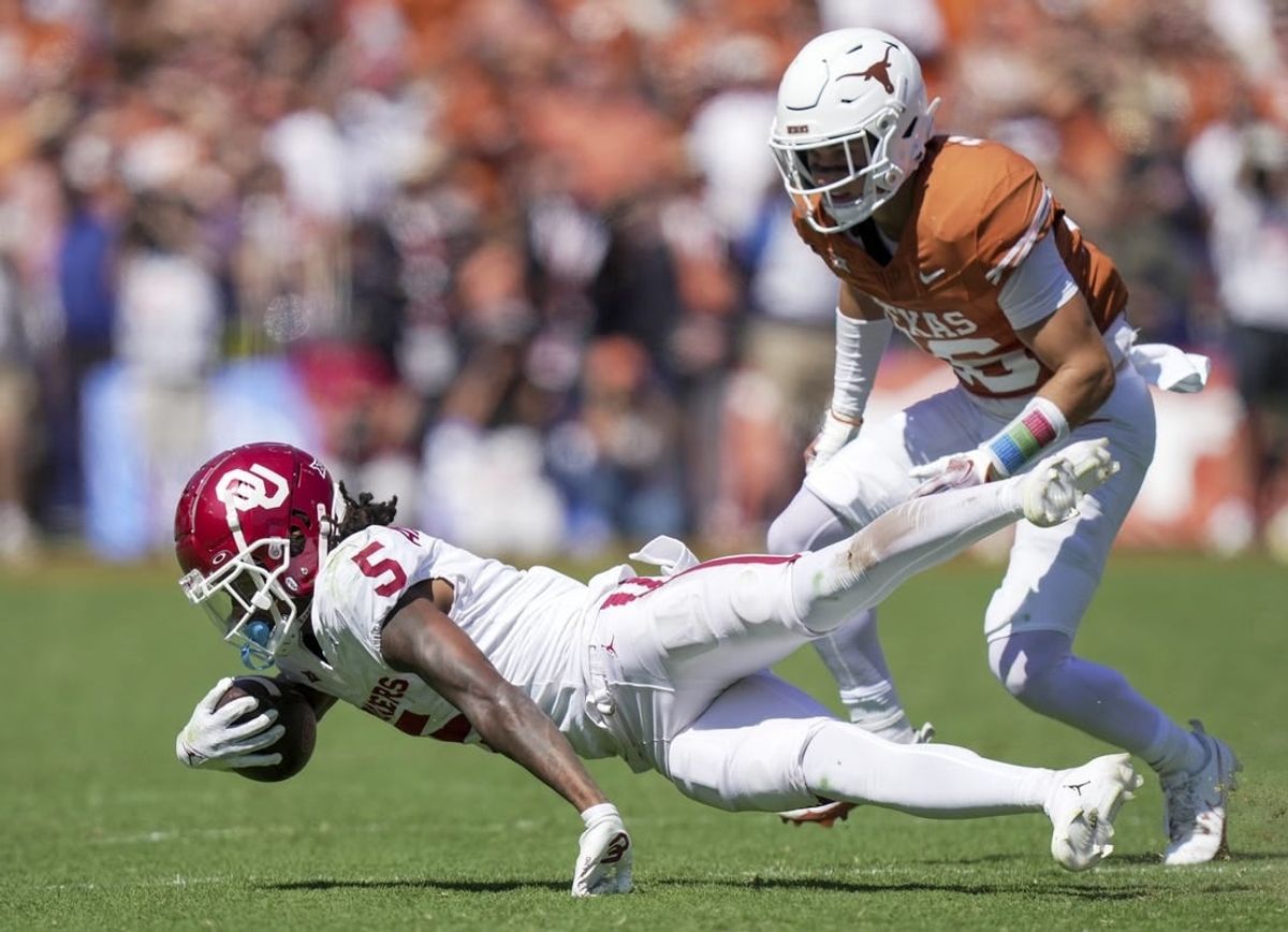 Oct 7, 2023; Dallas, Texas, USA; Oklahoma Sooners wide receiver Andrel Anthony (5) fights for yardage against the Texas Longhorns at the Cotton Bowl. This game makes up the 119th rivalry match up.