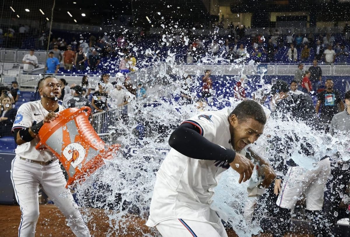 Apr 30, 2024; Miami, Florida, USA;  Miami Marlins second baseman Luis Arraez (3) douses outfielder Dane Myers (54) after he had the winning hit against the Colorado Rockies  at loanDepot Park.