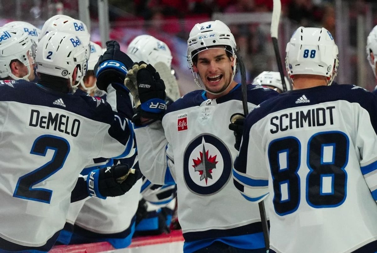 Mar 2, 2024; Raleigh, North Carolina, USA; Winnipeg Jets center Sean Monahan (23) is congratulated after his goal against the Carolina Hurricanes during the third period at PNC Arena.