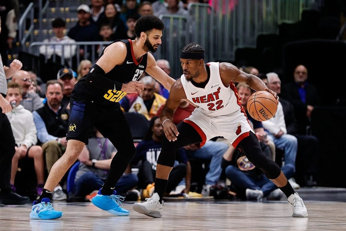 Feb 29, 2024; Denver, Colorado, USA; Miami Heat forward Jimmy Butler (22) controls the ball as Denver Nuggets guard Jamal Murray (27) guards in the first quarter at Ball Arena.
