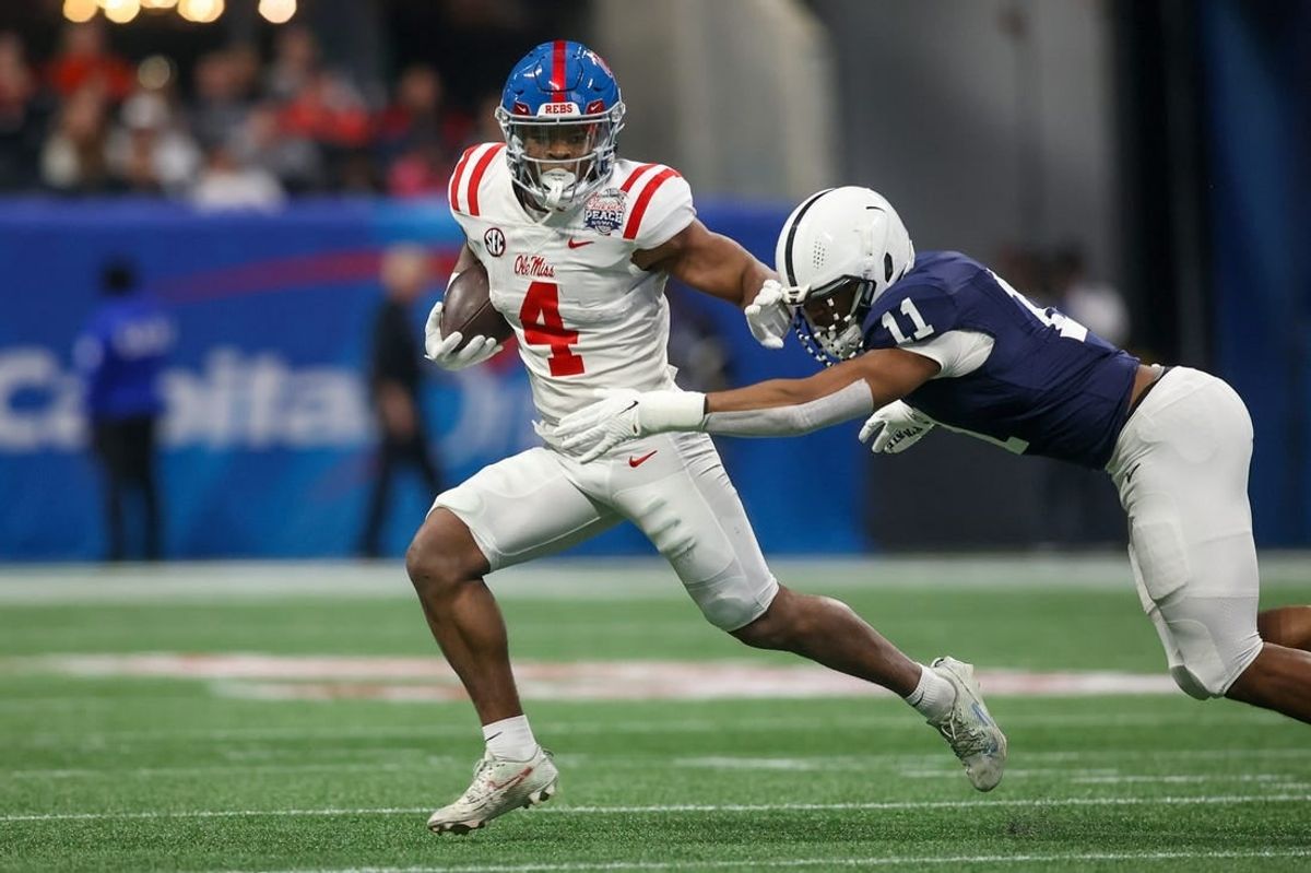Dec 30, 2023; Atlanta, GA, USA; Mississippi Rebels running back Quinshon Judkins (4) is tackled by Penn State Nittany Lions linebacker Abdul Carter (11) in the first quarter at Mercedes-Benz Stadium.