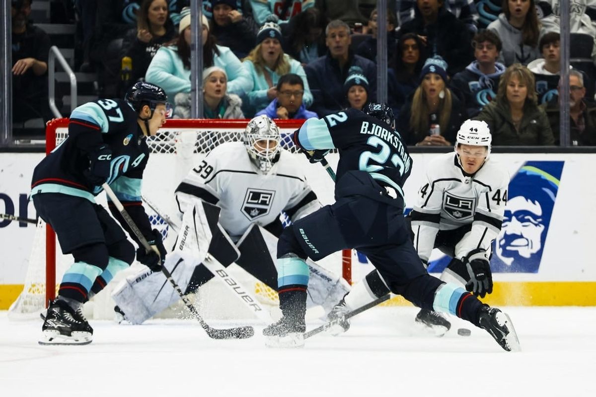 Dec 16, 2023; Seattle, Washington, USA; Los Angeles Kings defenseman Mikey Anderson (44) blocks a shot by Seattle Kraken right wing Oliver Bjorkstrand (22) during the first period at Climate Pledge Arena. Seattle Kraken center Yanni Gourde (37) and Los Angeles Kings goaltender Cam Talbot (39) follow the play at left.