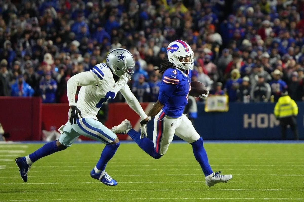 Dec 17, 2023; Orchard Park, New York, USA; Buffalo Bills running back James Cook (4) runs the ball pressured by Dallas Cowboys cornerback Jourdan Lewis (2) in the first half at Highmark Stadium.