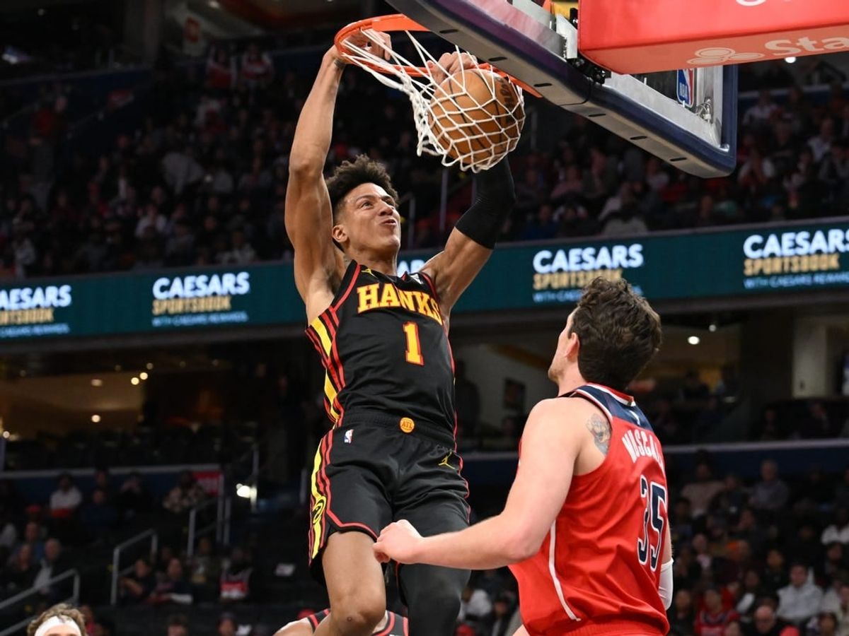 Dec 31, 2023; Washington, District of Columbia, USA;  Atlanta Hawks forward Jalen Johnson (1) dunks the ball as Washington Wizards center Mike Muscala (35) looks on during the first half at Capital One Arena.