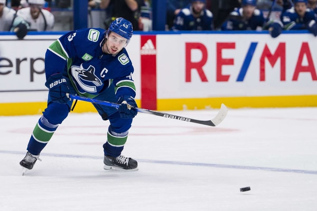 Nov 18, 2023; Vancouver, British Columbia, CAN; Vancouver Canucks defenseman Quinn Hughes (43) makes a pass against the Seattle Kraken in the third period at Rogers Arena. Seattle won 4-3.