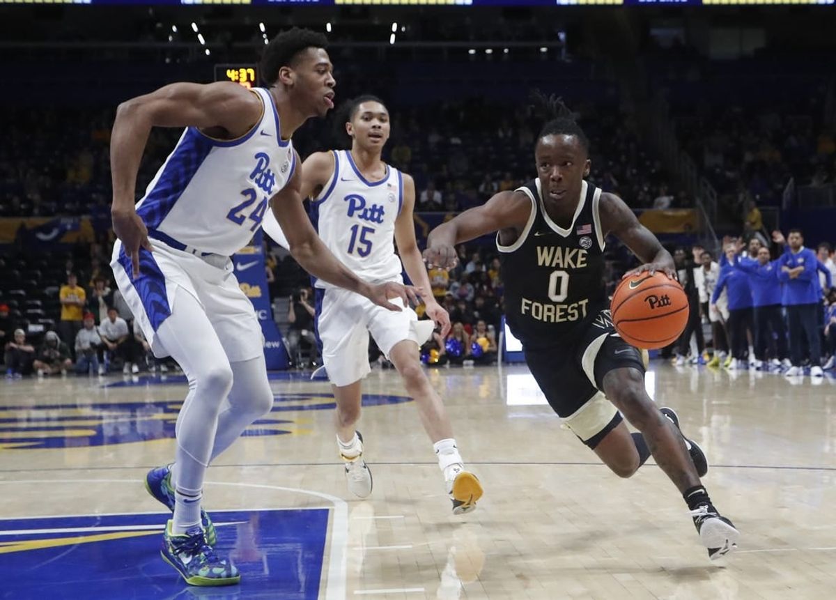 Jan 31, 2024; Pittsburgh, Pennsylvania, USA; Wake Forest Demon Deacons guard Kevin Miller (0) drives to the basket past Pittsburgh Panthers forward William Jeffress (24) and guard Jaland Lowe (15) during the second half at the Petersen Events Center. Pittsburgh won 77-72.
