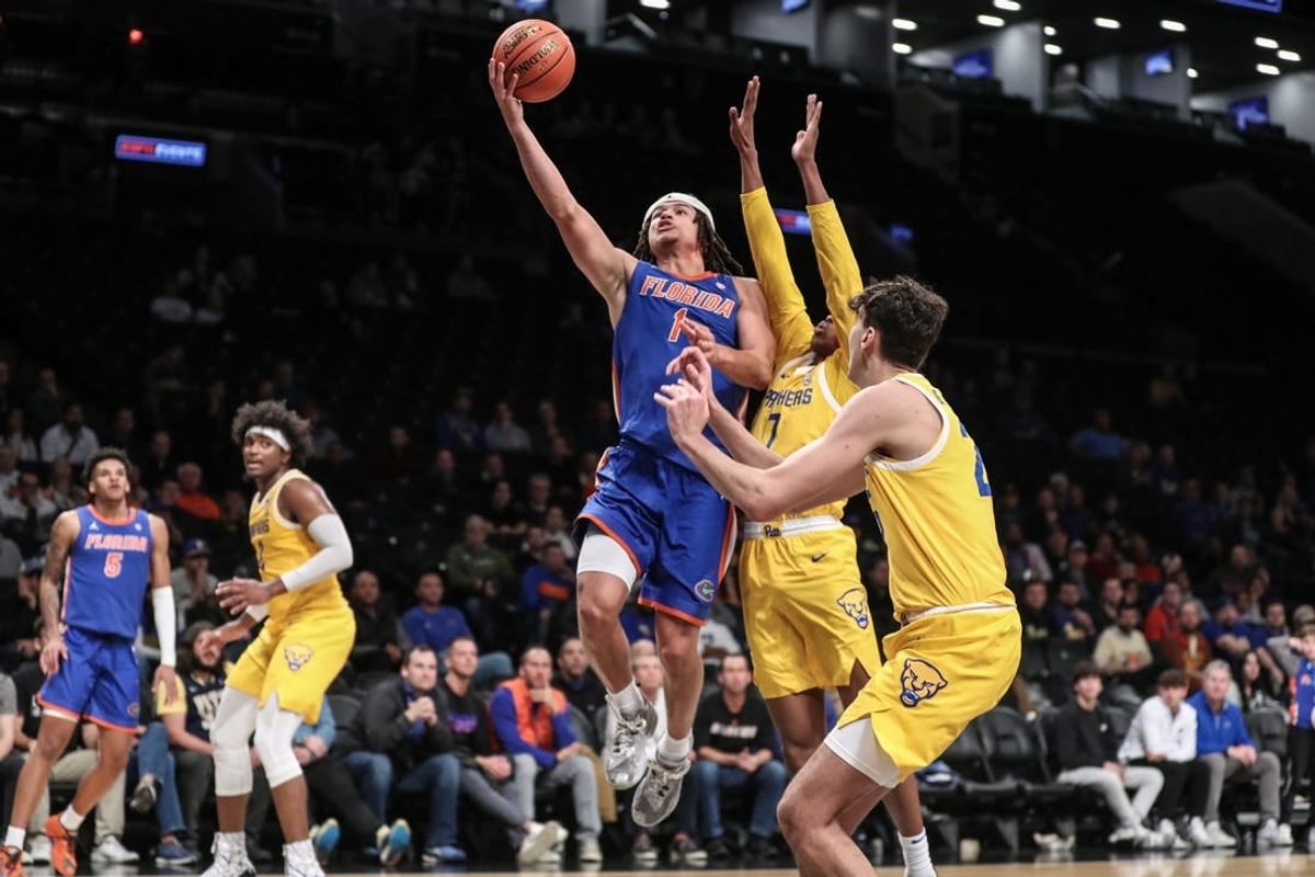 Nov 22, 2023; Brooklyn, New York, USA; Florida Gators guard Walter Clayton Jr. (1) drives past Pittsburgh Panthers guard Carlton Carrington (7) for a layup in the second half at Barclays Center.