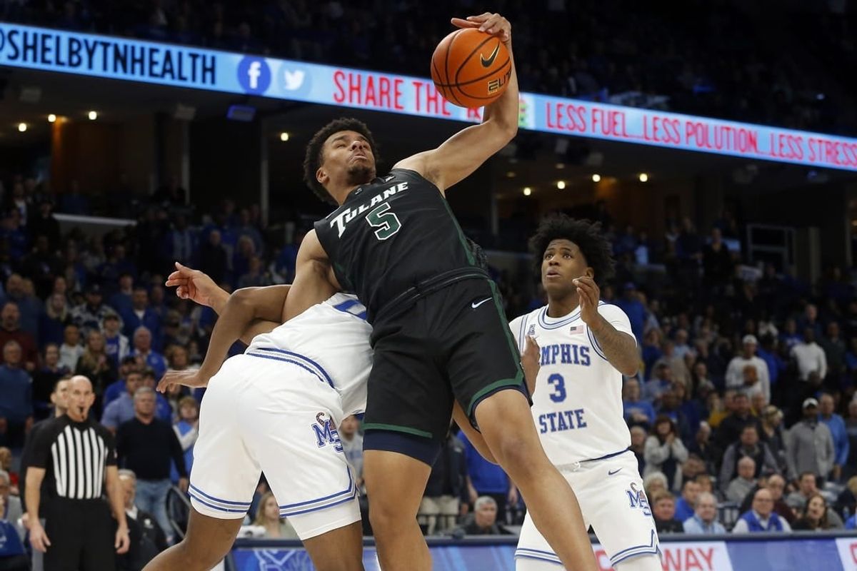 Feb 4, 2023; Memphis, Tennessee, USA; Tulane Green Wave forward Collin Holloway (5) collects a rebound as he is pulled to the ground by Memphis Tigers guard Elijah McCadden (0) during the second half at FedExForum.