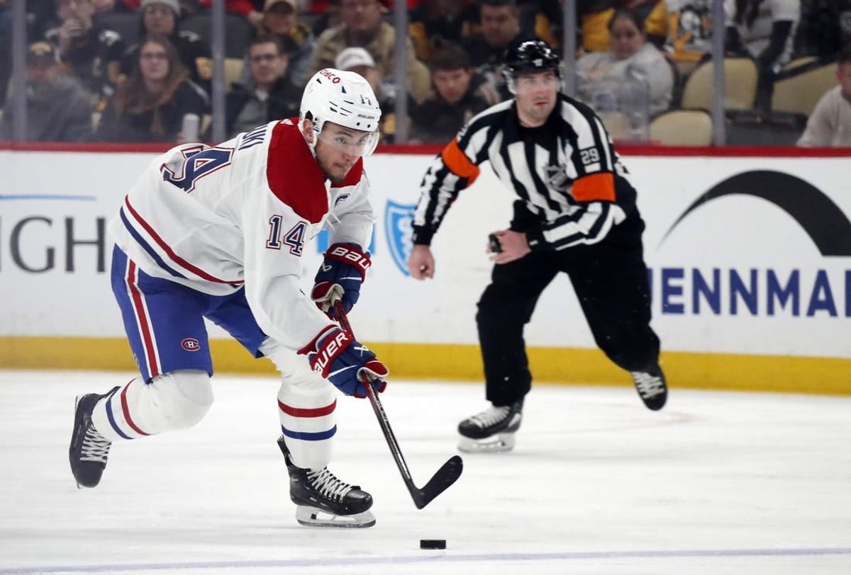Feb 22, 2024; Pittsburgh, Pennsylvania, USA; Montreal Canadiens center Nick Suzuki (14) skates up ice with the puck against the Pittsburgh Penguins during the second period at PPG Paints Arena.