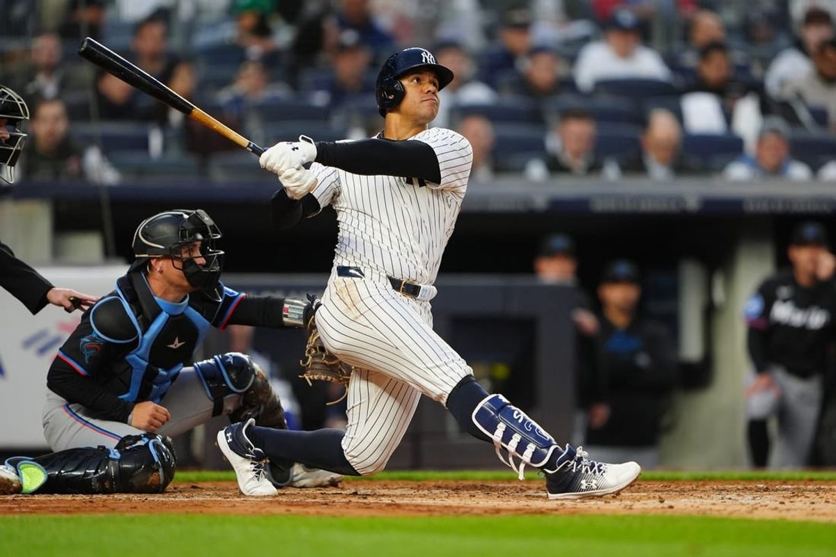 Apr 8, 2024; Bronx, New York, USA; New York Yankees right fielder Juan Soto (22) hits a three run home run against the Miami Marlins during the fourth inning at Yankee Stadium.