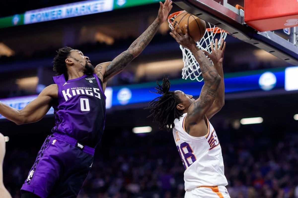 Dec 22, 2023; Sacramento, California, USA; Sacramento Kings guard Malik Monk (0) blocks a shot by Phoenix Suns guard Saben Lee (38) during the second quarter at Golden 1 Center.