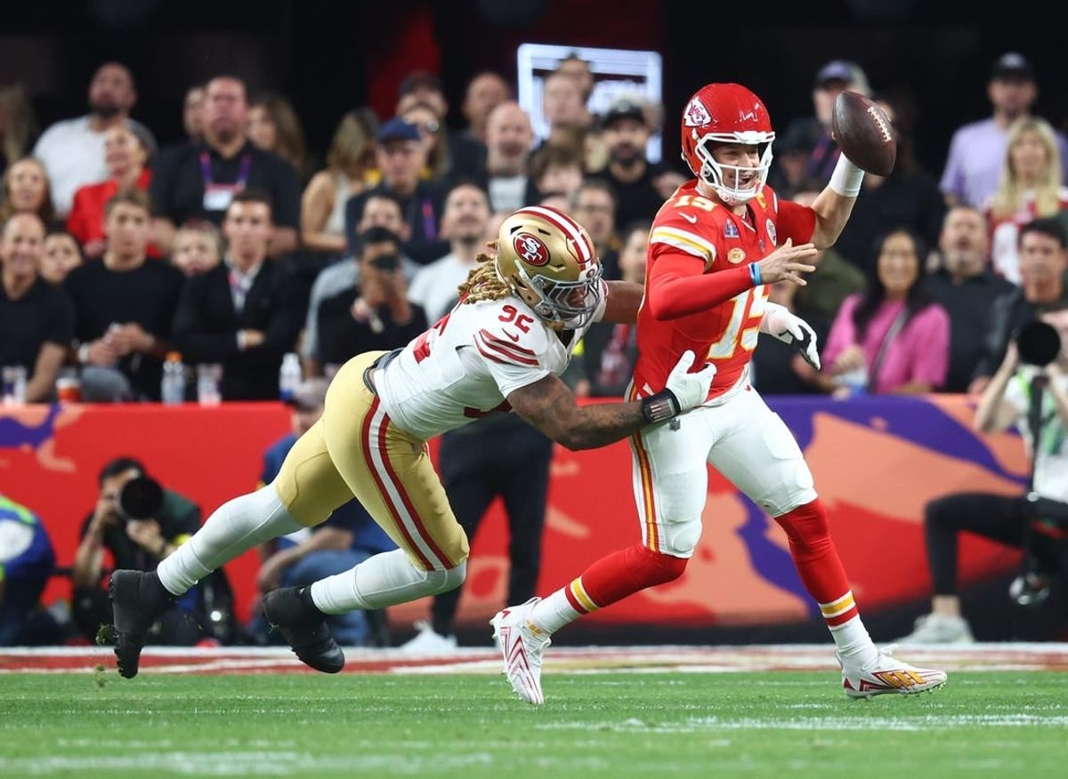 Feb 11, 2024; Paradise, Nevada, USA; Kansas City Chiefs quarterback Patrick Mahomes (15) is pressured by San Francisco 49ers defensive end Chase Young (92) in the first half in Super Bowl LVIII at Allegiant Stadium.