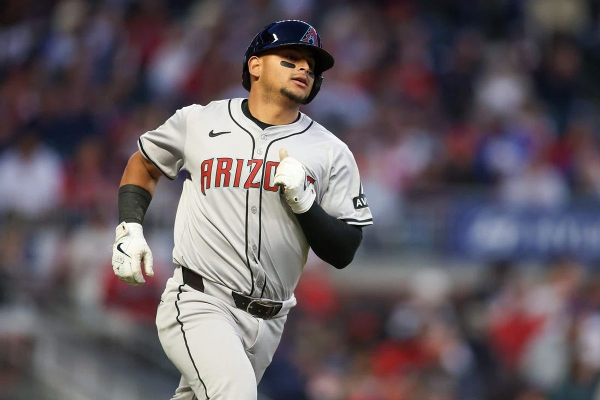 Apr 6, 2024; Atlanta, Georgia, USA; Arizona Diamondbacks catcher Gabriel Moreno (14) hits a single against the Atlanta Braves in the third inning at Truist Park.