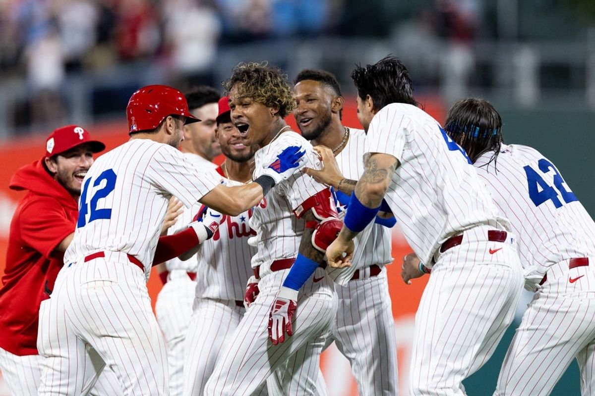Apr 15, 2024; Philadelphia, Pennsylvania, USA; Philadelphia Phillies outfielder Cristian Pache (M) celebrates with teammates after hitting a walk off RBI single during the tenth inning against the Colorado Rockies at Citizens Bank Park.