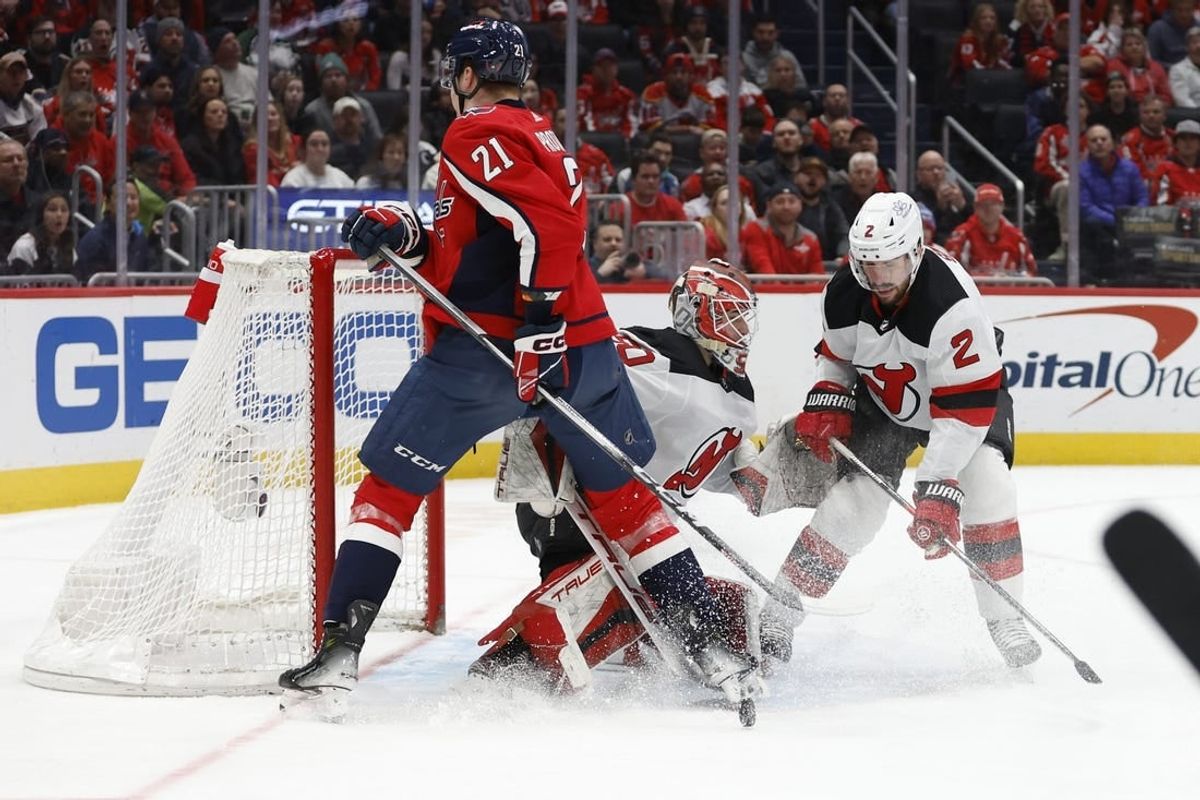 Jan 3, 2024; Washington, District of Columbia, USA; New Jersey Devils goaltender Nico Daws (50) makes a save in front of Washington Capitals center Aliaksei Protas (21) and Devils defenseman Brendan Smith (2) in the first period at Capital One Arena.