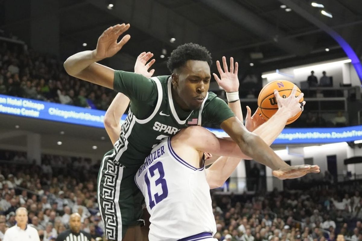 Jan 7, 2024; Evanston, Illinois, USA; Michigan State Spartans forward Xavier Booker (34) defends Northwestern Wildcats guard Brooks Barnhizer (13) during the second half at Welsh-Ryan Arena.