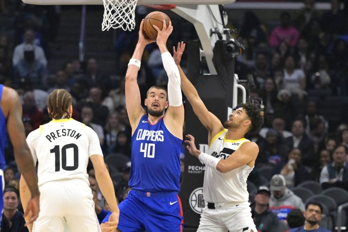 Apr 5, 2024; Los Angeles, California, USA; Utah Jazz guard Johnny Juzang (33) defends Los Angeles Clippers center Ivica Zubac (40) in the first half at Crypto.com Arena.