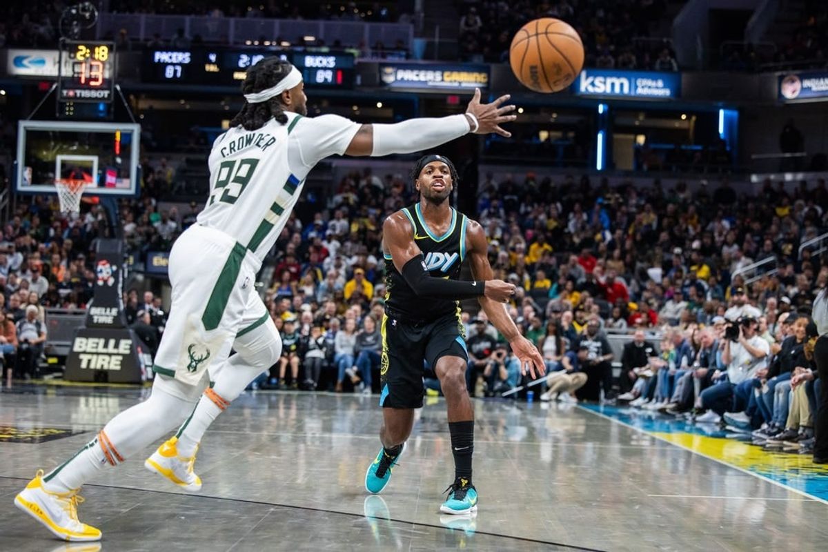 Nov 9, 2023; Indianapolis, Indiana, USA; Indiana Pacers guard Buddy Hield (7) passes the ball while Milwaukee Bucks forward Jae Crowder (99) defends in the second half at Gainbridge Fieldhouse.