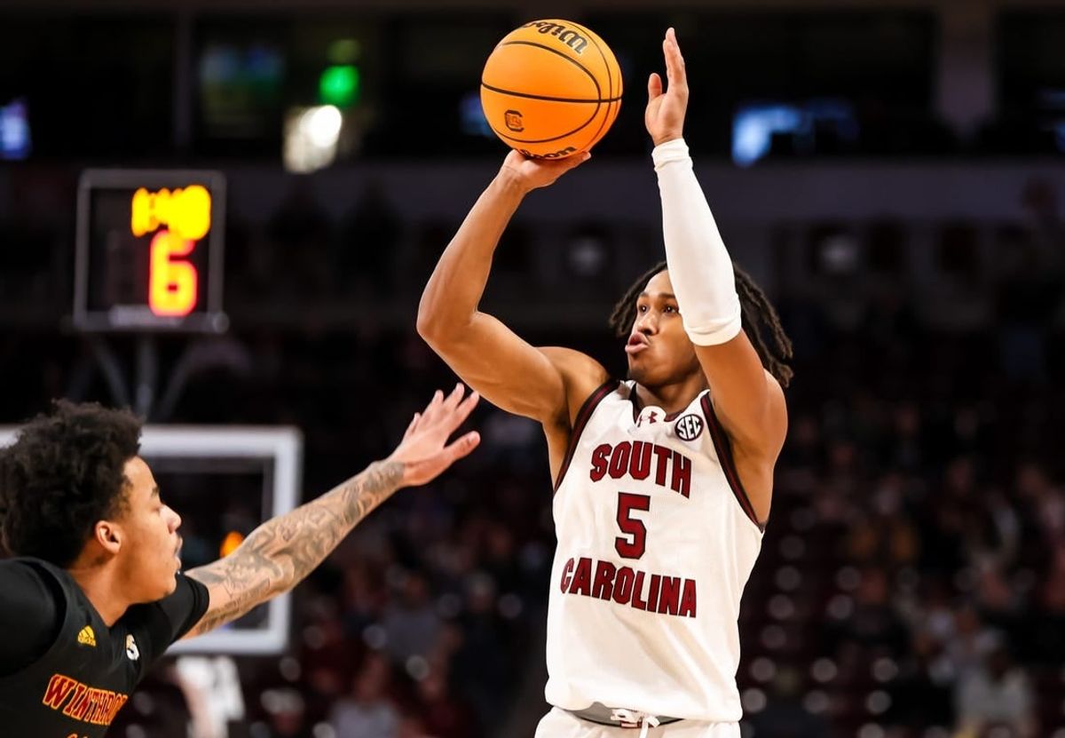 Dec 19, 2023; Columbia, South Carolina, USA; South Carolina Gamecocks guard Meechie Johnson (5) shoots over Winthrop Eagles guard Kasen Harrison (11) in the first half at Colonial Life Arena.