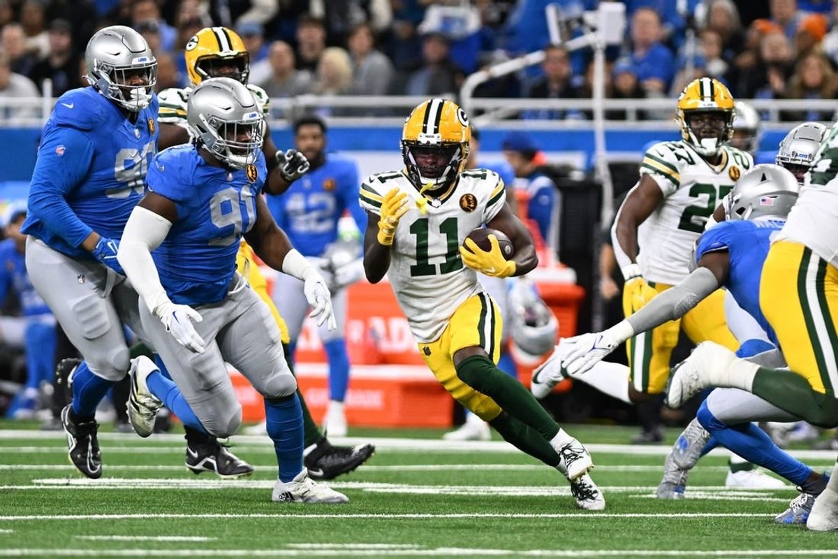 Nov 23, 2023; Detroit, Michigan, USA; Green Bay Packers wide receiver Jayden Reed (11) runs the ball against the Detroit Lions in the first quarter at Ford Field.