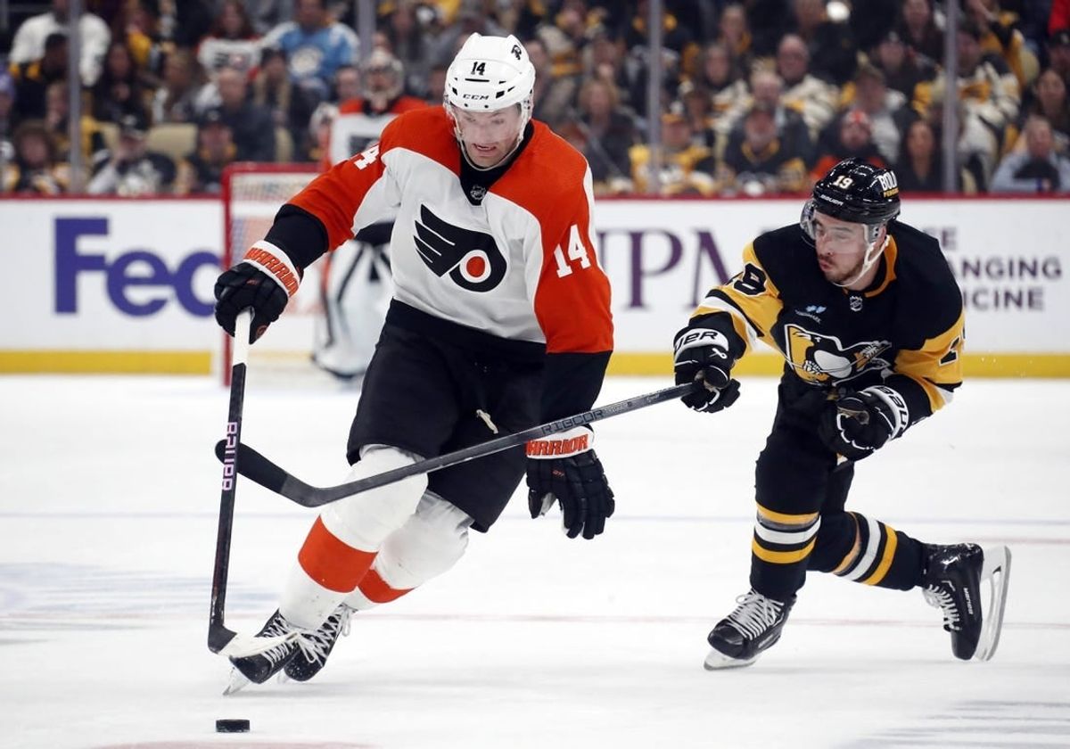 Dec 2, 2023; Pittsburgh, Pennsylvania, USA; Philadelphia Flyers center Sean Couturier (14) moves the puck up ice pat Pittsburgh Penguins right wing Reilly Smith (19) during the second period at PPG Paints Arena.