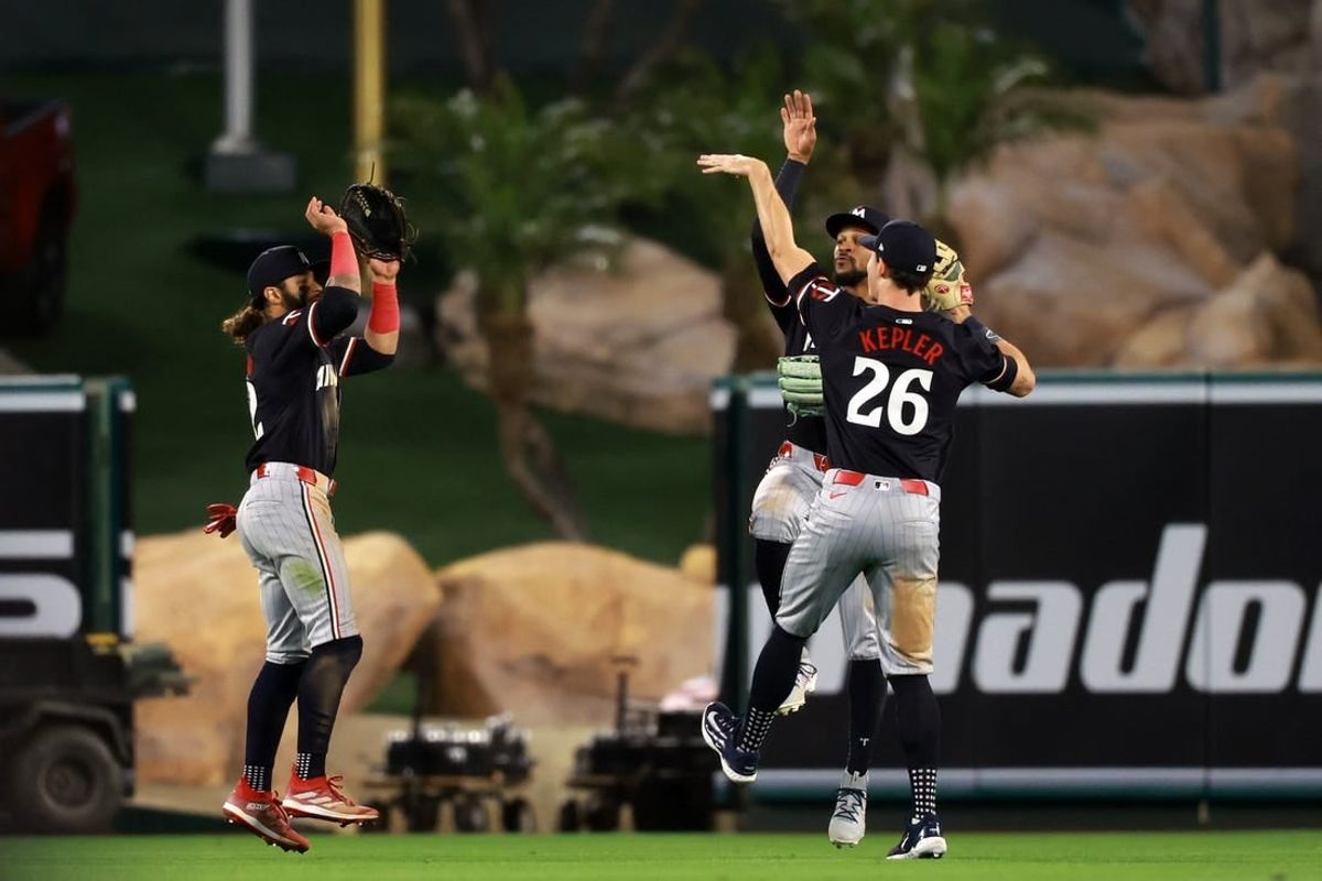 Apr 26, 2024; Anaheim, California, USA;  Minnesota Twins outfielders Austin Martin (82) and Byron Buxton (25) and Max Kepler (26) celebrate a victory after defeating the Los Angeles Angels 5-3 at Angel Stadium.
