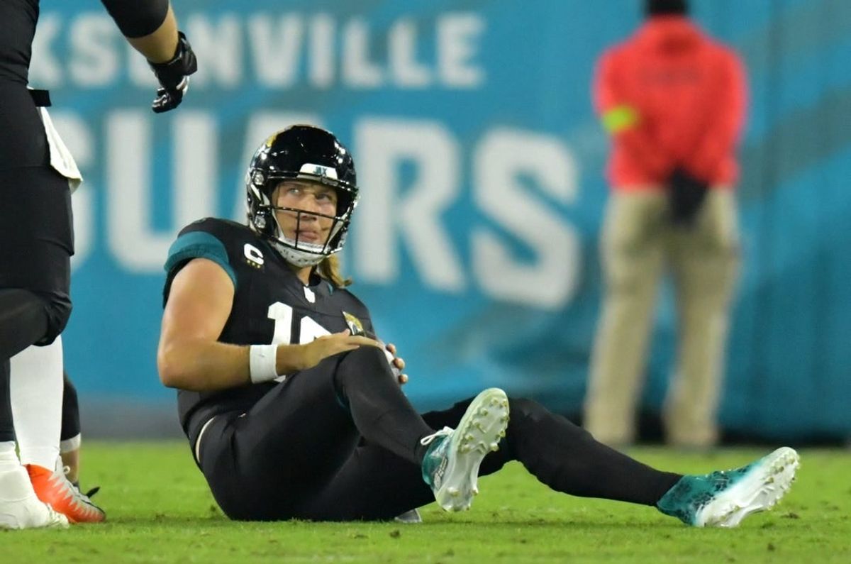 Jacksonville Jaguars quarterback Trevor Lawrence (16) looks up at a teammate after getting tackled by Cincinnati Bengals defensive end Sam Hubbard (94) late in the second quarter. The Jacksonville Jaguars hosted the Cincinnati Bengals at EverBank Stadium in Jacksonville, Florida for Monday Night Football, December 4, 2023. The Jaguars were tied 14 to 14 at the end of the first half. [Bob Self/Florida Times-Union]