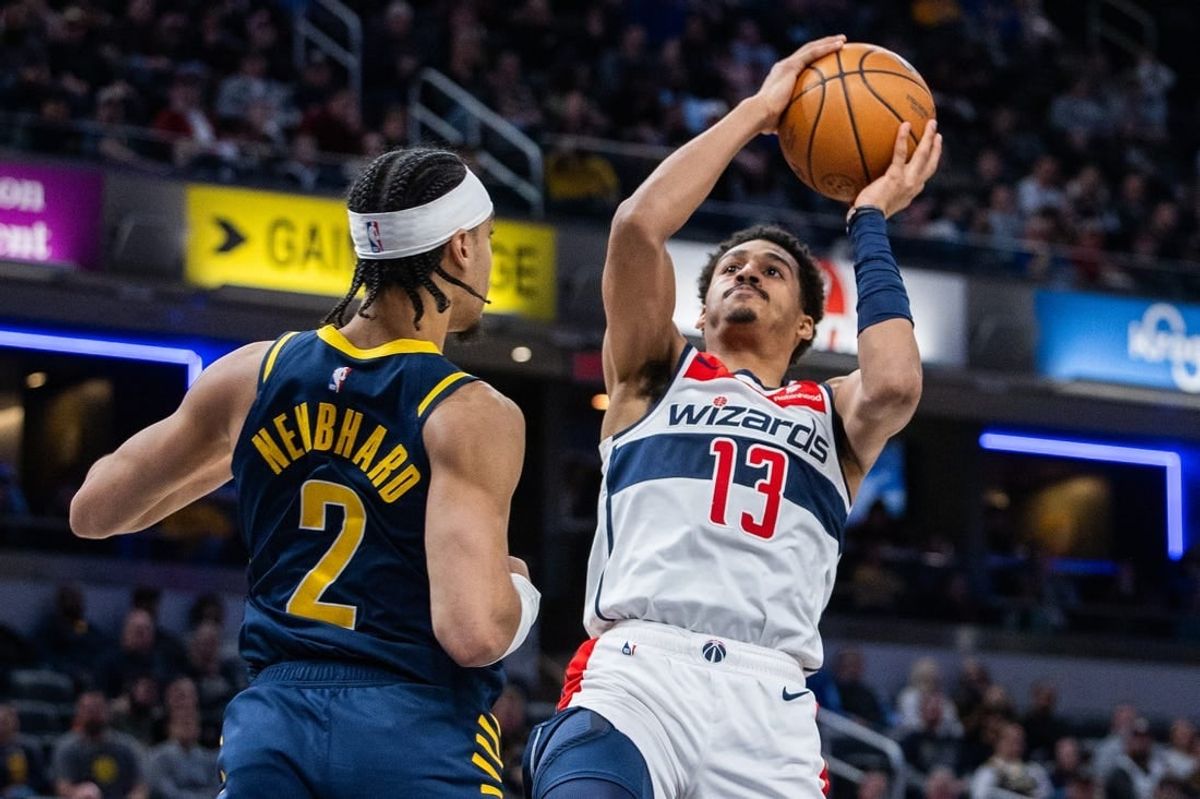 Jan 10, 2024; Indianapolis, Indiana, USA; Washington Wizards guard Jordan Poole (13) shoots the ball while Indiana Pacers guard Andrew Nembhard (2) defends in the first half at Gainbridge Fieldhouse.