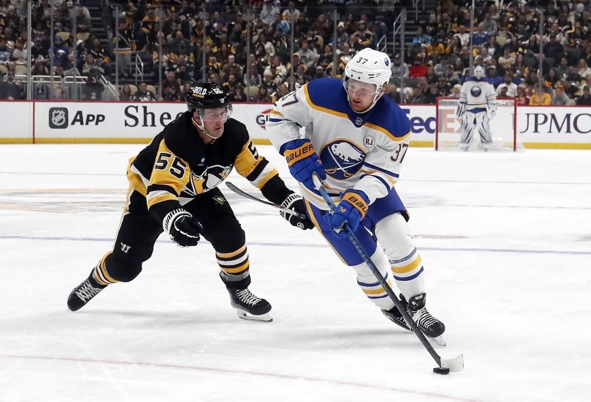 Jan 6, 2024; Pittsburgh, Pennsylvania, USA;  Buffalo Sabres center Casey Mittelstadt (37) skates with the puck against Pittsburgh Penguins center Noel Acciari (55) during the second period at PPG Paints Arena. Buffalo won 3-1.