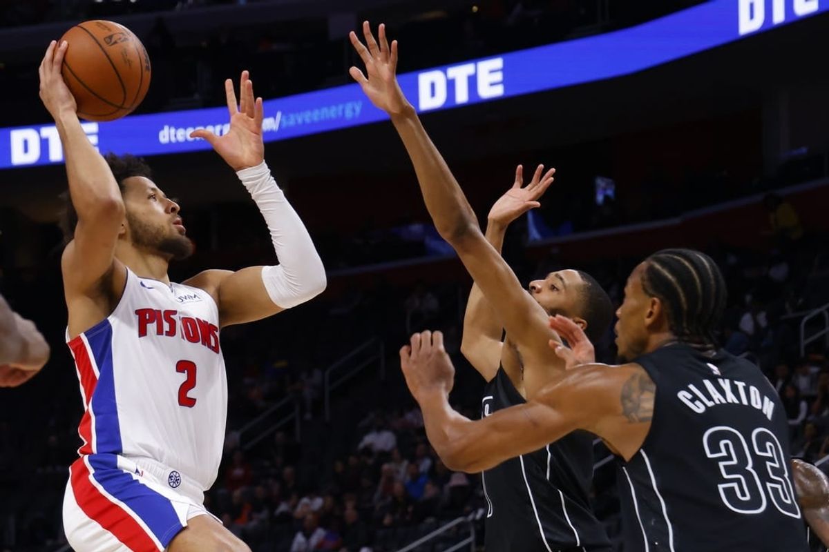 Mar 7, 2024; Detroit, Michigan, USA;  Detroit Pistons guard Cade Cunningham (2) shoots over Brooklyn Nets center Nic Claxton (33) in the first half at Little Caesars Arena.