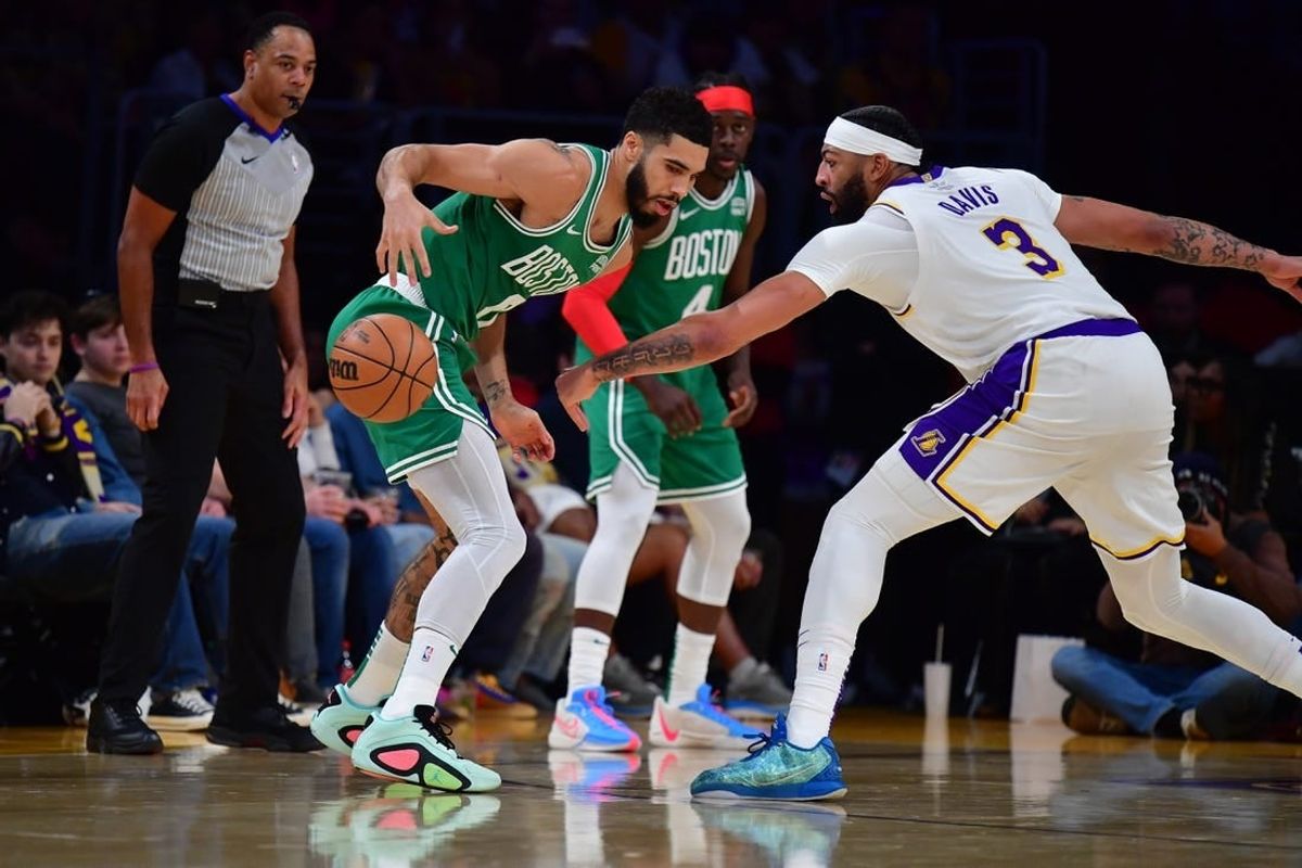 Dec 25, 2023; Los Angeles, California, USA; Boston Celtics forward Jayson Tatum (0) loses the ball against Los Angeles Lakers forward Anthony Davis (3) during the first half at Crypto.com Arena.
