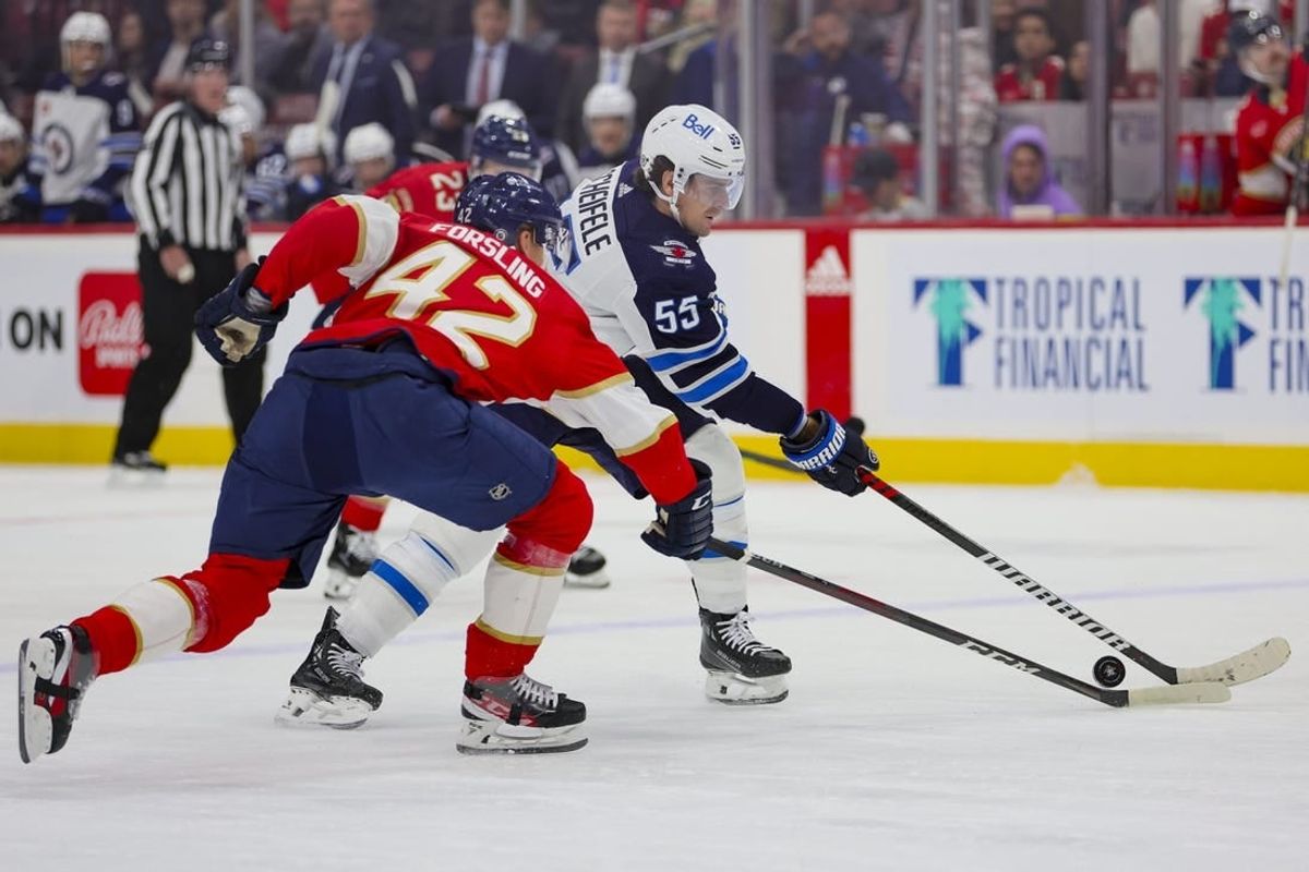 Nov 24, 2023; Sunrise, Florida, USA; Winnipeg Jets center Mark Scheifele (55) moves the puck against Florida Panthers defenseman Gustav Forsling (42) during the first period at Amerant Bank Arena.