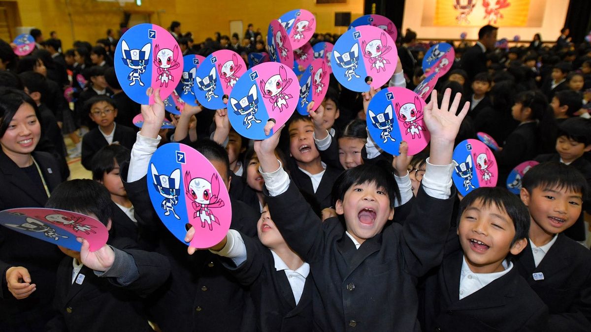 Students at the Hoyonomori Gakuen School cheer the selection of the 2020 Olympic and Paralympic mascots.