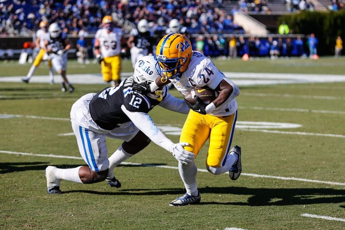 Nov 25, 2023; Durham, North Carolina, USA; Duke Blue Devils linebacker Tre Freeman (12) tacks Pittsburgh Panthers running back C'Bo Flemister (24) during the first half of the game at Wallace Wade Stadium.