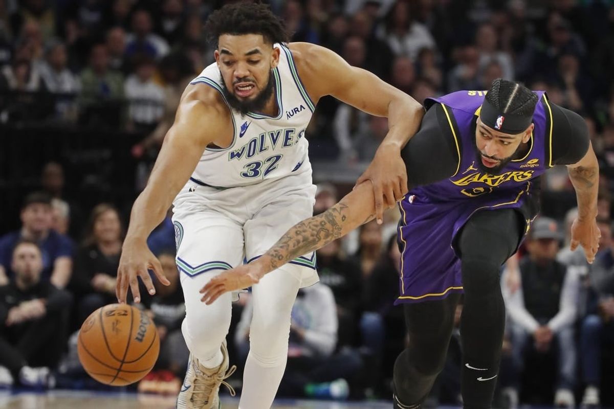 Dec 30, 2023; Minneapolis, Minnesota, USA; Los Angeles Lakers forward Anthony Davis (3) knocks the ball away from Minnesota Timberwolves forward Karl-Anthony Towns (32) in the first quarter at Target Center.