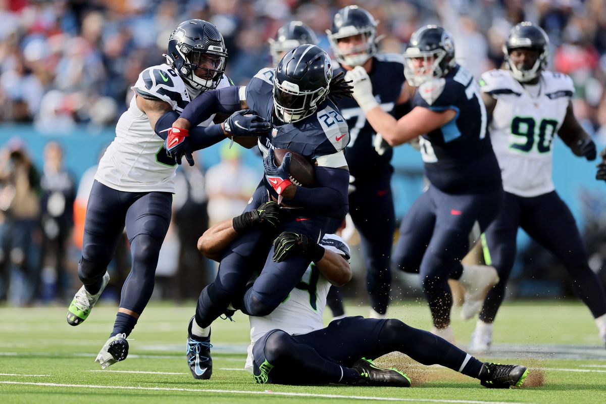 NASHVILLE, TENNESSEE - DECEMBER 24: Derrick Henry #22 of the Tennessee Titans is tackled by Bobby Wagner #54 of the Seattle Seahawks during the first half at Nissan Stadium on December 24, 2023 in Nashville, Tennessee. (Photo by Andy Lyons/Getty Images)