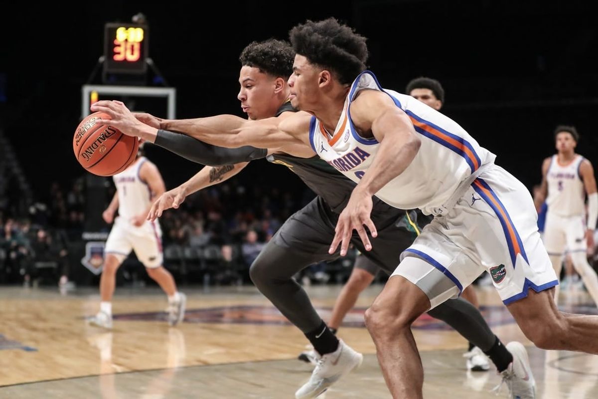 Nov 24, 2023; Brooklyn, NY, USA;  Florida Gators guard Zyon Pullin (0) and Baylor Bears guard Miro Little (1) fight for a loose ball in the first half at Barclay Center.