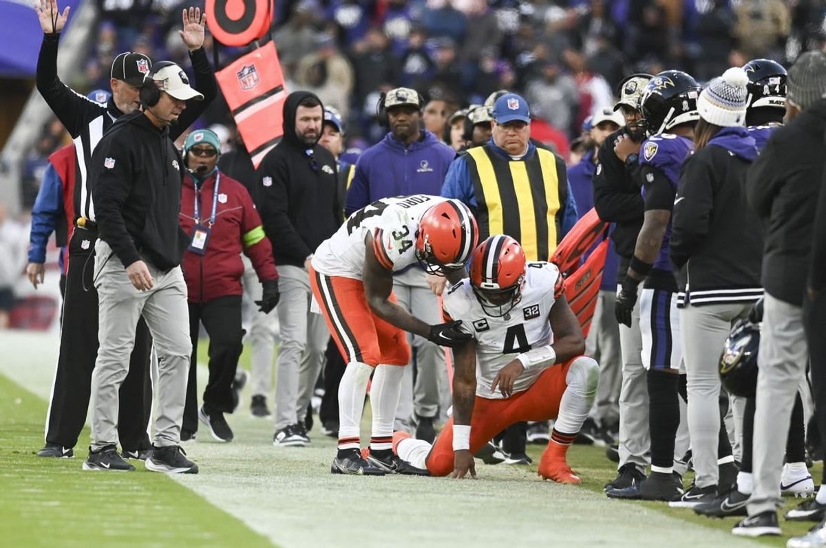 Nov 12, 2023; Baltimore, Maryland, USA;  Cleveland Browns quarterback Deshaun Watson (4) is helped up by  running back Jerome Ford (34) after being tackled out of bounds during the second half against the Baltimore Ravens at M&T Bank Stadium.