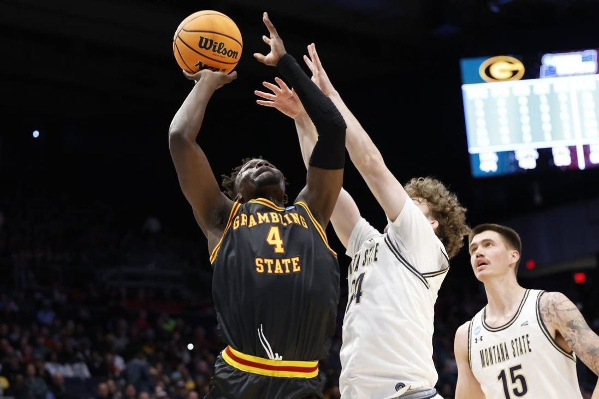 Mar 20, 2024; Dayton, OH, USA; Grambling State Tigers forward Antwan Burnett (4) goes to the basket defended by Montana State Bobcats guard Jed Miller (24) in the first half  at UD Arena.