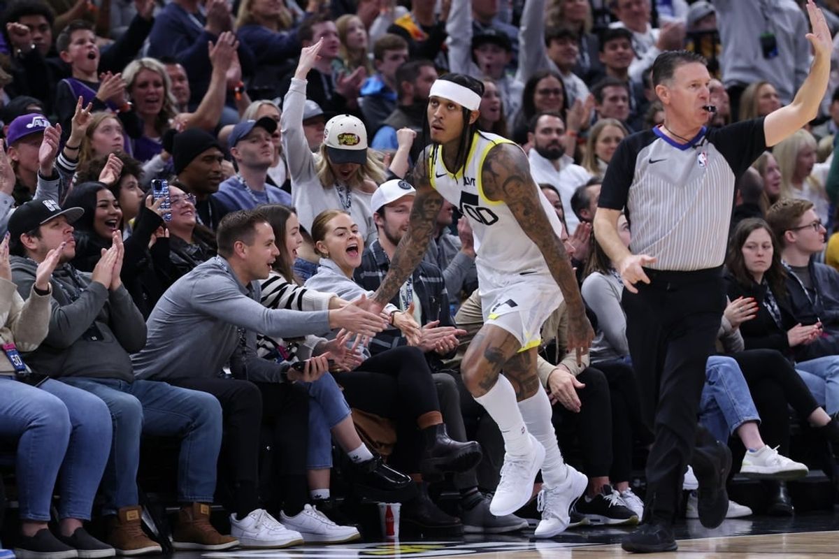 Jan 13, 2024; Salt Lake City, Utah, USA; Utah Jazz guard Jordan Clarkson (00) slaps hands with fans after making a three point basket against the Los Angeles Lakers during the second quarter at Delta Center.