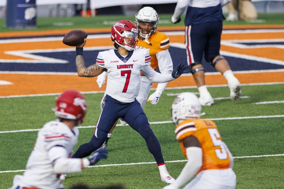 Nov 25, 2023; El Paso, Texas, USA; No. 22 Liberty Flames quarterback Kaidon Salter (7) tries throws the ball against the UTEP Miners defense during the first half at Sun Bowl Stadium.