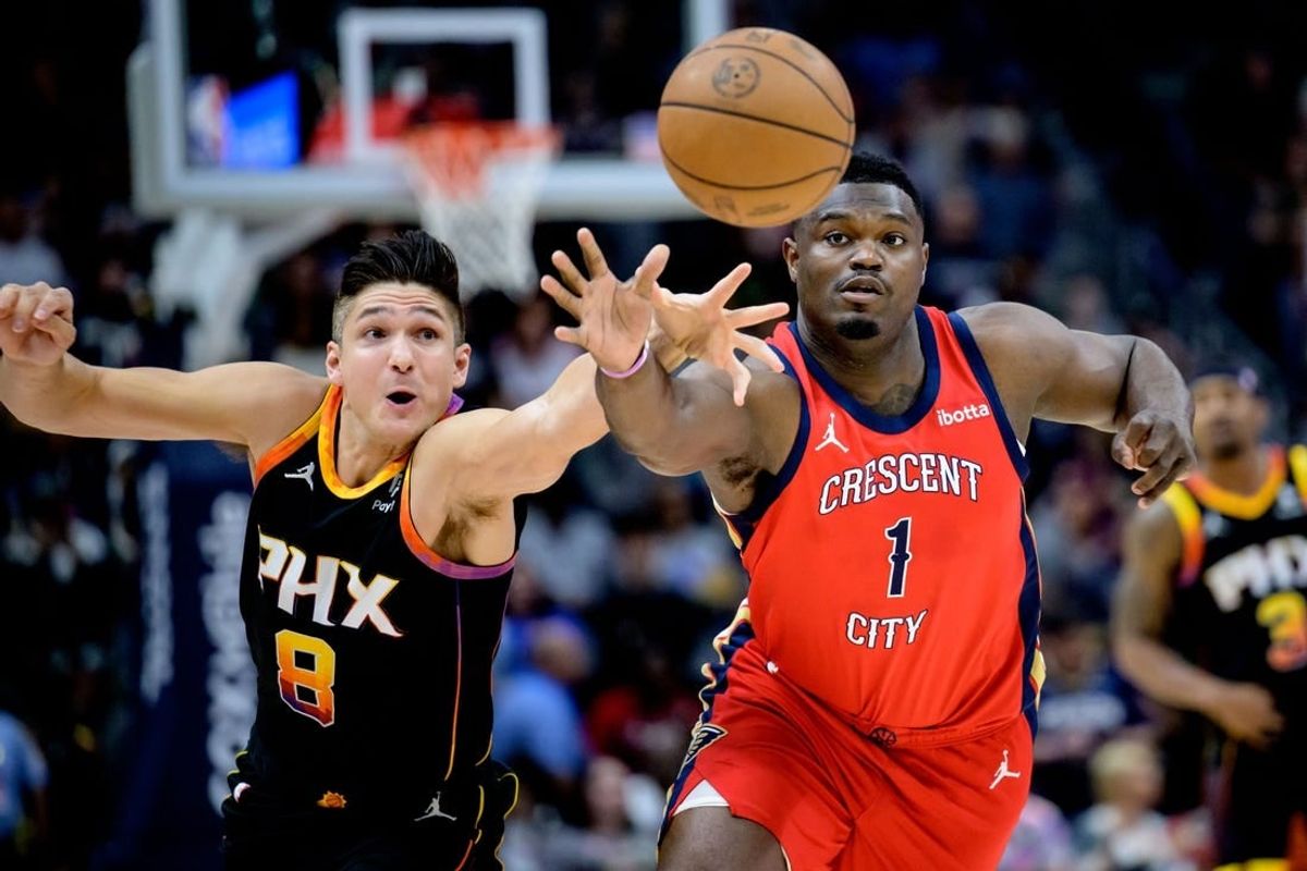 Apr 1, 2024; New Orleans, Louisiana, USA; New Orleans Pelicans forward Zion Williamson (1) battles Phoenix Suns guard Grayson Allen (8) for the ball during the first quarter at Smoothie King Center.